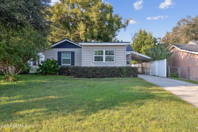 view of front facade with a front lawn and a carport