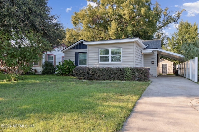 view of front facade with a front yard and a carport