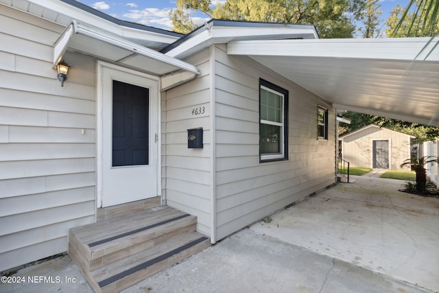 property entrance with a carport