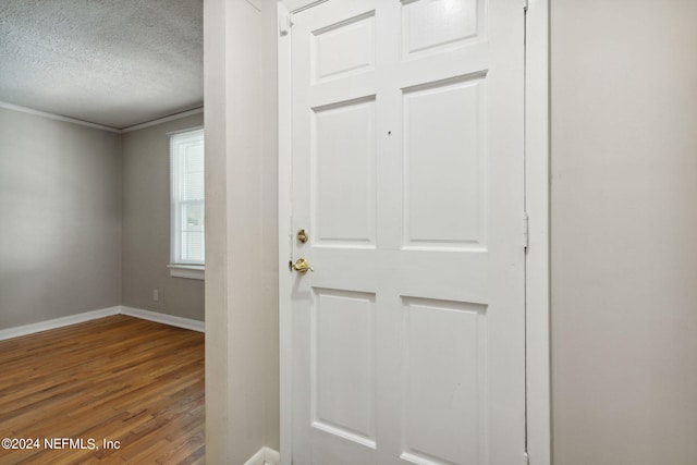 entryway with a textured ceiling and hardwood / wood-style floors