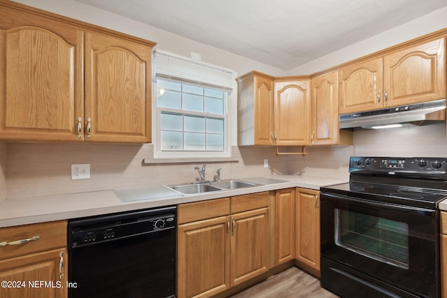 kitchen with light hardwood / wood-style flooring, black appliances, and sink