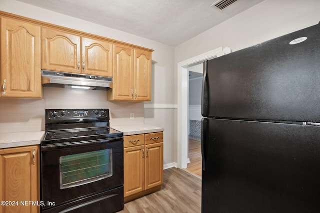 kitchen with black appliances, light hardwood / wood-style flooring, and light brown cabinets