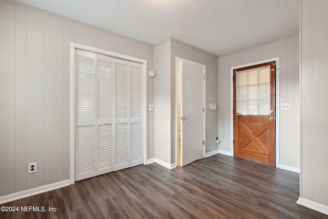 interior space with wood walls and dark hardwood / wood-style flooring