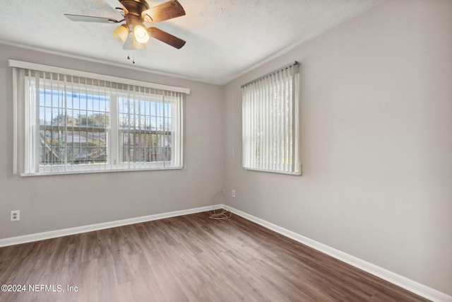 unfurnished room with ceiling fan, hardwood / wood-style flooring, and a textured ceiling