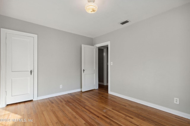 unfurnished bedroom with hardwood / wood-style floors