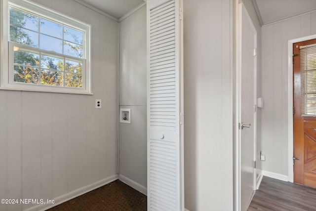 clothes washing area featuring wood walls, ornamental molding, washer hookup, and dark hardwood / wood-style flooring