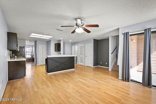 kitchen featuring a textured ceiling, light hardwood / wood-style flooring, and plenty of natural light