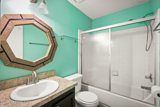 full bathroom with toilet, enclosed tub / shower combo, vanity, and a textured ceiling