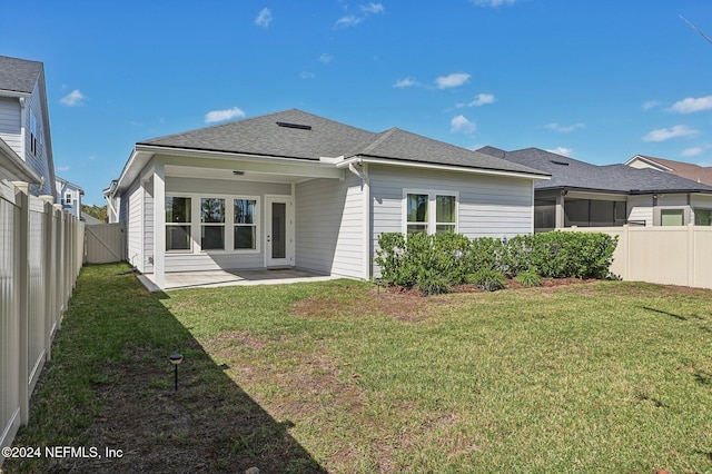 back of property with a patio and a lawn