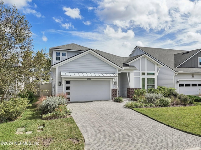 view of front facade with a front yard and a garage