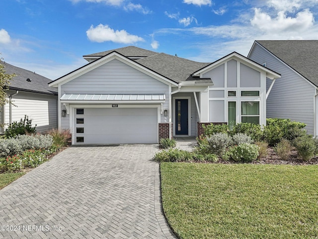 view of front facade with a front lawn and a garage