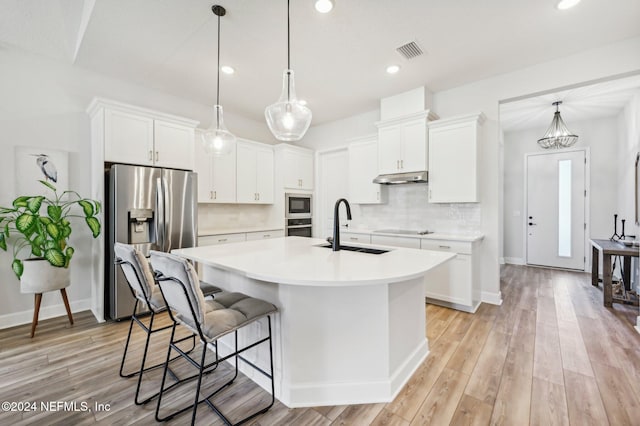 kitchen with sink, white cabinetry, light hardwood / wood-style flooring, and stainless steel appliances