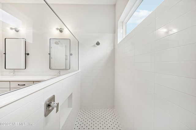 bathroom featuring vanity and tiled shower