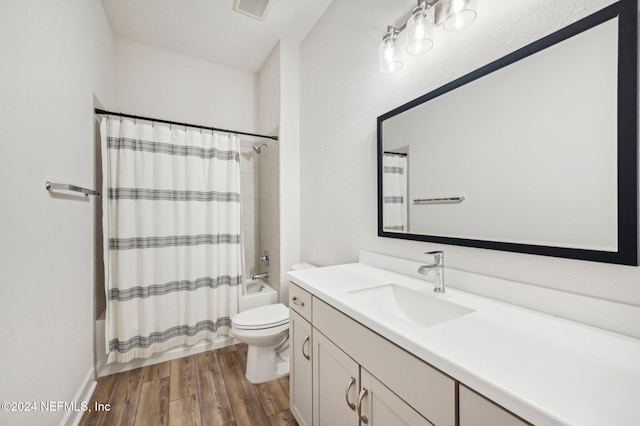 full bathroom with vanity, toilet, shower / bath combo with shower curtain, and wood-type flooring