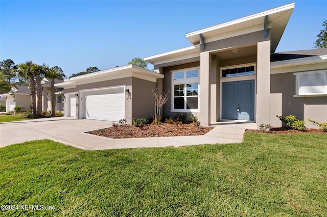 view of front of house with a front yard and a garage