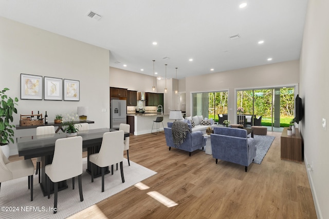 dining space with light hardwood / wood-style floors