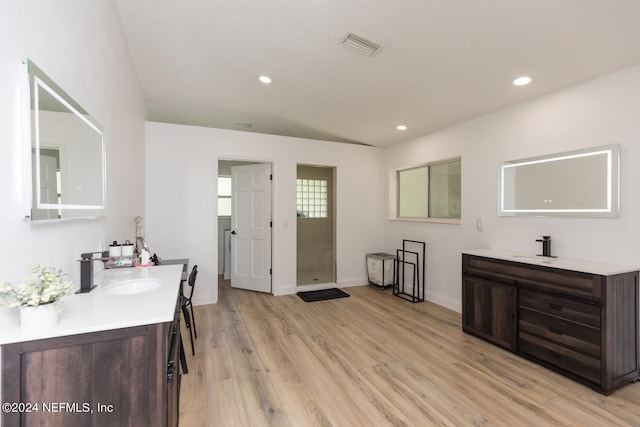 bathroom with vanity, walk in shower, and hardwood / wood-style floors