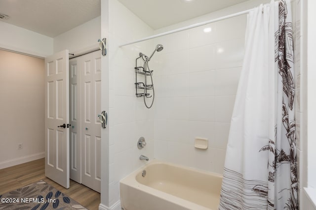 bathroom with shower / bath combo with shower curtain and hardwood / wood-style flooring