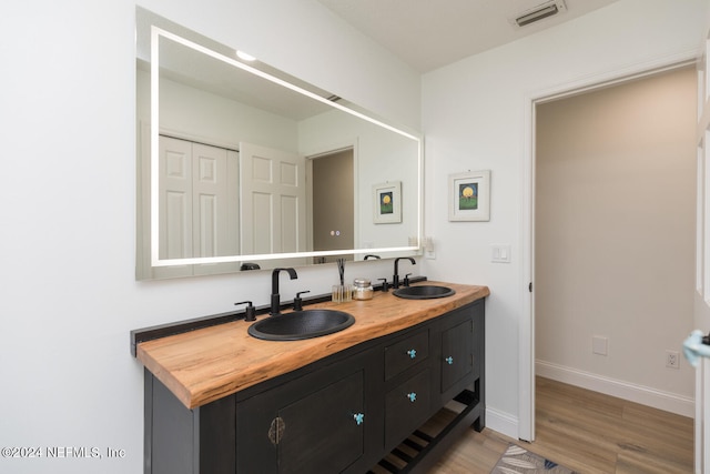 bathroom featuring vanity and hardwood / wood-style flooring