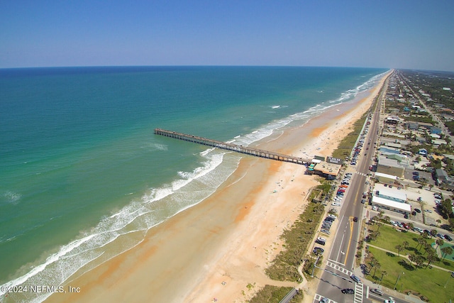 bird's eye view featuring a water view and a beach view