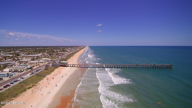 bird's eye view featuring a water view and a beach view