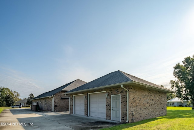 view of property exterior featuring a lawn and a garage