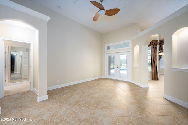 tiled spare room with french doors, crown molding, and ceiling fan