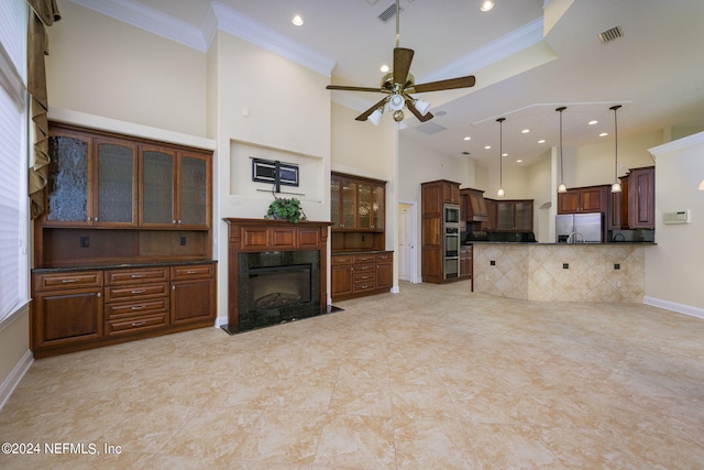 living room featuring ornamental molding, a towering ceiling, and ceiling fan