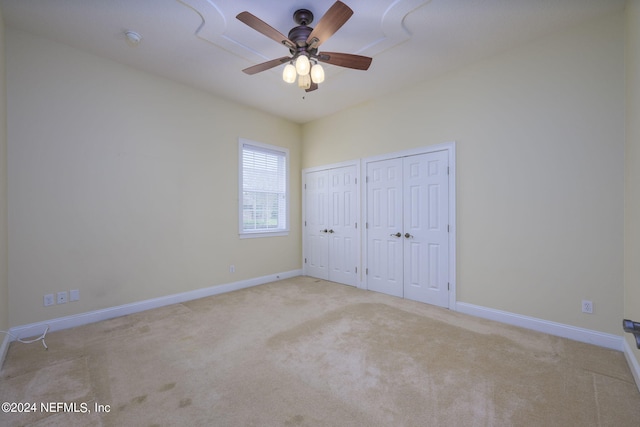 235 Crystal Cove Dr, Palatka, FL 32177 - unfurnished bedroom with two closets, baseboards, a ceiling fan, and carpet floors