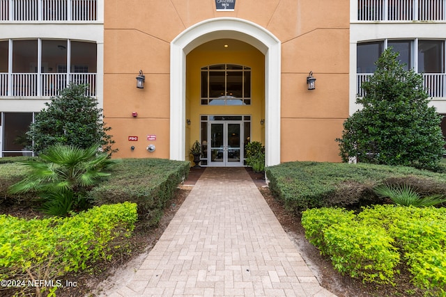 entrance to property with a balcony and french doors