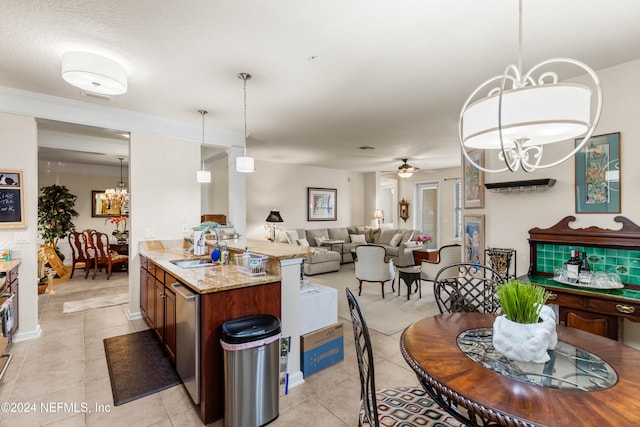 kitchen featuring ceiling fan with notable chandelier, sink, light tile patterned flooring, light stone countertops, and pendant lighting