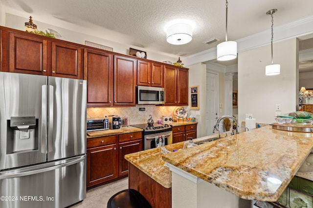 9831 Del Webb Pkwy Unit 2308, Jacksonville, FL 32256 - kitchen featuring appliances with stainless steel finishes, a peninsula, decorative backsplash, light stone countertops, and decorative light fixtures