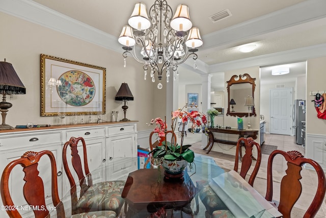 dining area with a notable chandelier, light tile patterned floors, and crown molding