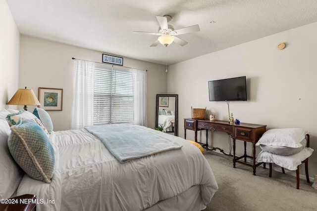 bedroom featuring ceiling fan, a textured ceiling, and carpet flooring