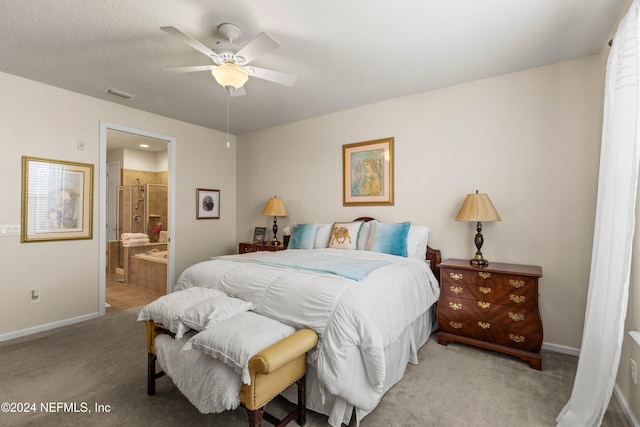 bedroom with ceiling fan, connected bathroom, and light colored carpet