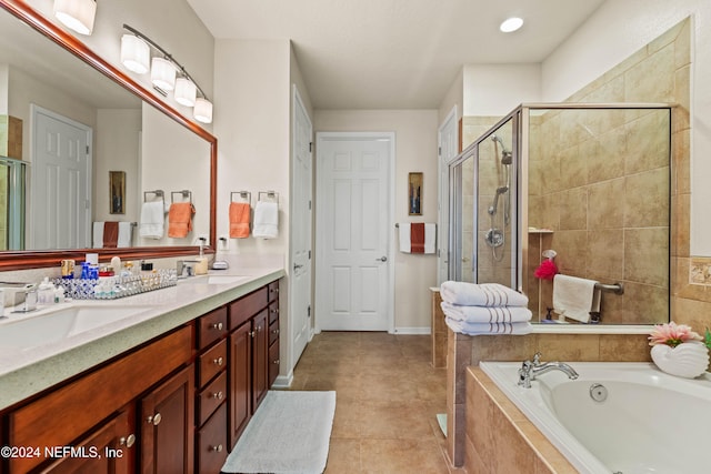 bathroom with tile patterned flooring, vanity, and separate shower and tub