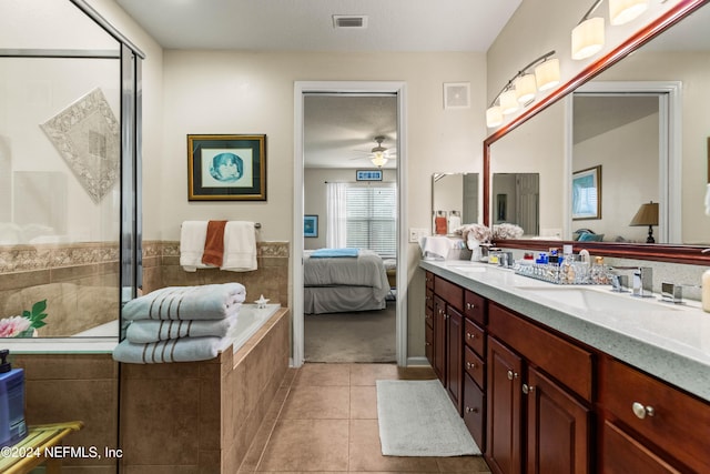 bathroom featuring vanity, ceiling fan, tile patterned floors, and a relaxing tiled tub