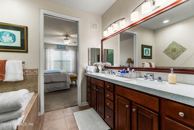 9831 Del Webb Pkwy Unit 2308, Jacksonville, FL 32256 - bathroom featuring tile patterned floors, double vanity, connected bathroom, tiled tub, and a ceiling fan