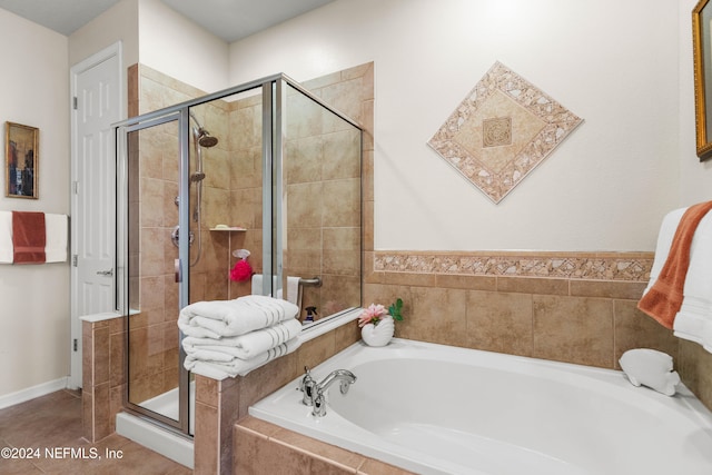 bathroom with tile patterned floors and shower with separate bathtub