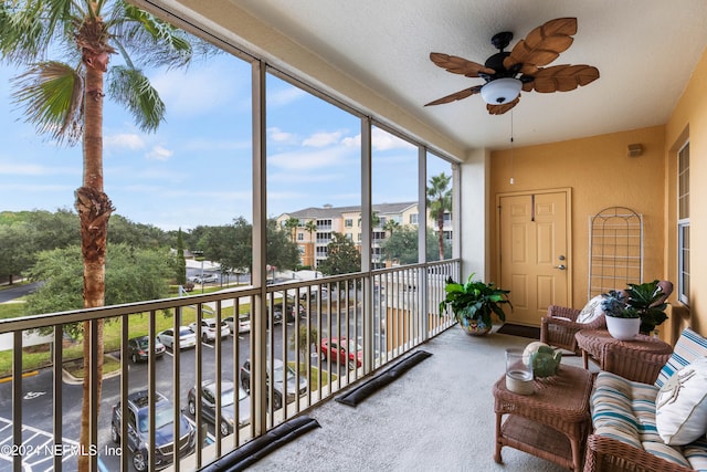 sunroom featuring ceiling fan