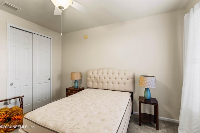 carpeted bedroom with a closet and ceiling fan