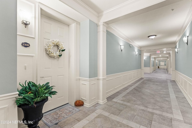 9831 Del Webb Pkwy Unit 2308, Jacksonville, FL 32256 - hall featuring a decorative wall, a wainscoted wall, ornamental molding, and ornate columns