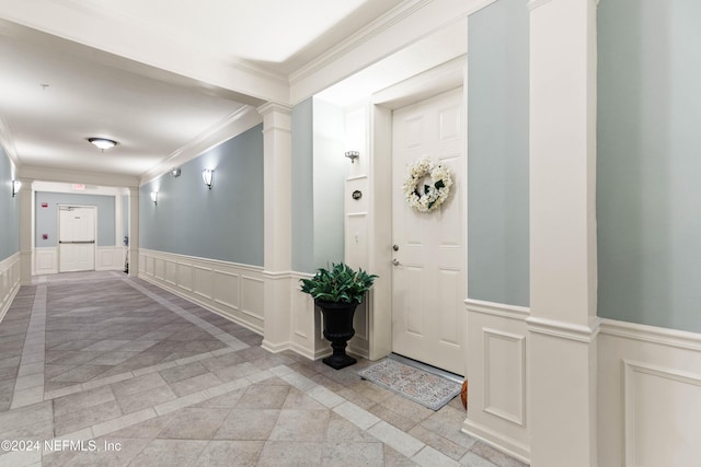 9831 Del Webb Pkwy Unit 2308, Jacksonville, FL 32256 - foyer entrance featuring a decorative wall, a wainscoted wall, ornamental molding, decorative columns, and inlaid floor details