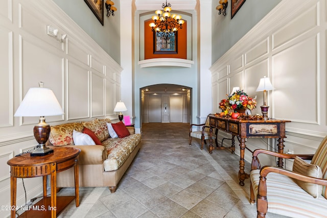 living room with a chandelier and a high ceiling