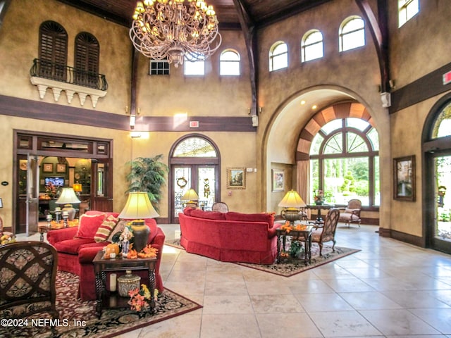 9831 Del Webb Pkwy Unit 2308, Jacksonville, FL 32256 - tiled living area with a high ceiling, healthy amount of natural light, a chandelier, a wood ceiling with exposed beams, and arched walkways