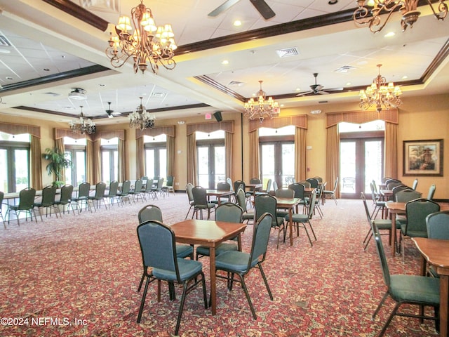 carpeted dining area with ceiling fan, a tray ceiling, french doors, and ornamental molding