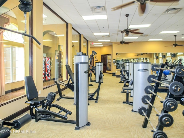 9831 Del Webb Pkwy Unit 2308, Jacksonville, FL 32256 - exercise room featuring a ceiling fan, carpet, arched walkways, and a drop ceiling
