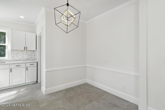 unfurnished dining area with light tile patterned flooring, crown molding, and a notable chandelier