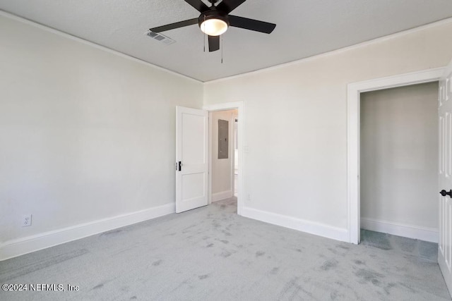 carpeted empty room with electric panel and ceiling fan