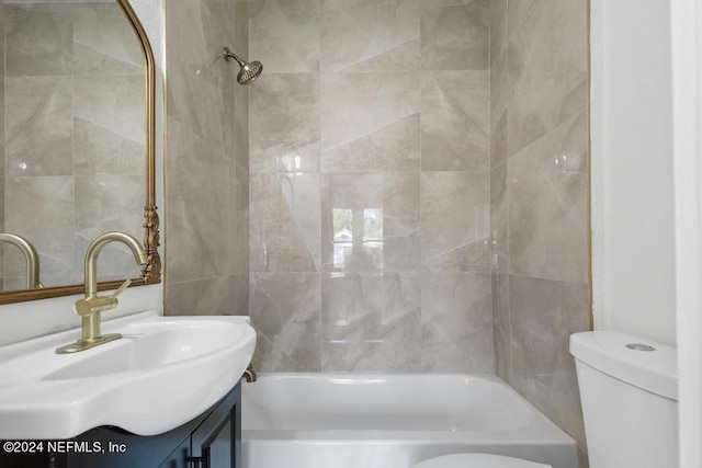 full bathroom featuring vanity, tiled shower / bath combo, and toilet